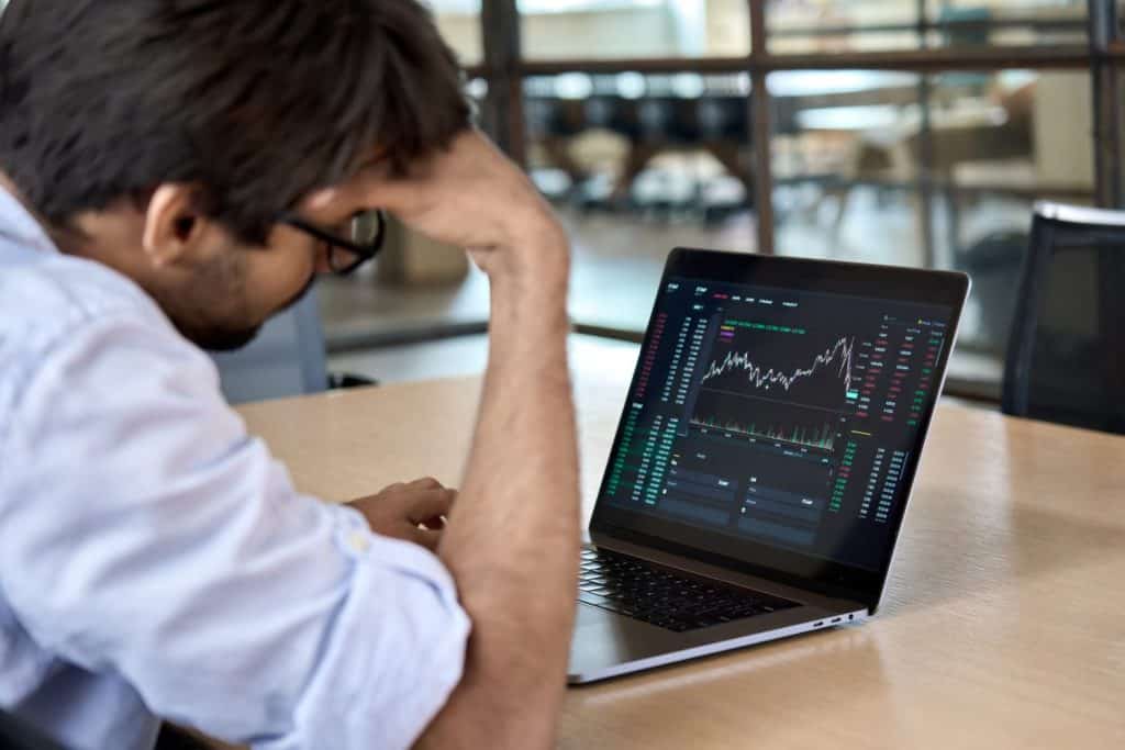 Stressed business man crypto trader broker investor analyzing stock exchange market crypto trading decreasing chart data fall down loss, desperate about losing money of crisis, recession, inflation.